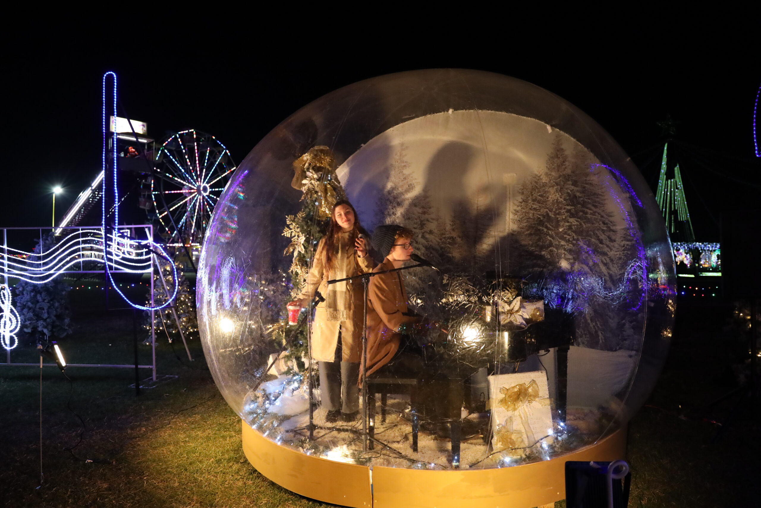 Live performer inside one of the oversized snow globes at the Maryland Holiday Light Spectacular
