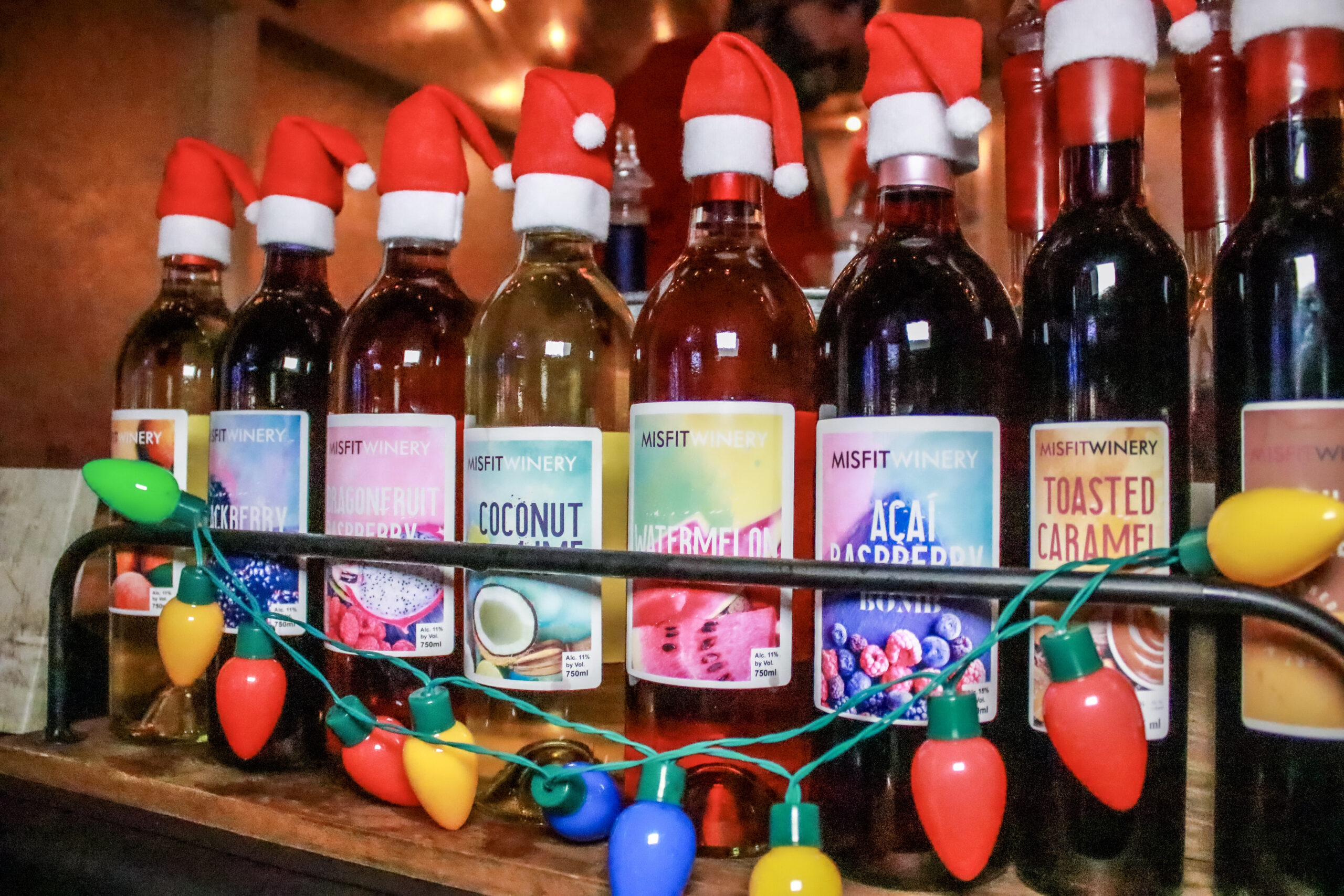 Bottles dressed in Santa hats at a Swiss Holiday Village vendor stand